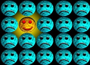 Happy face amongst sad faces.